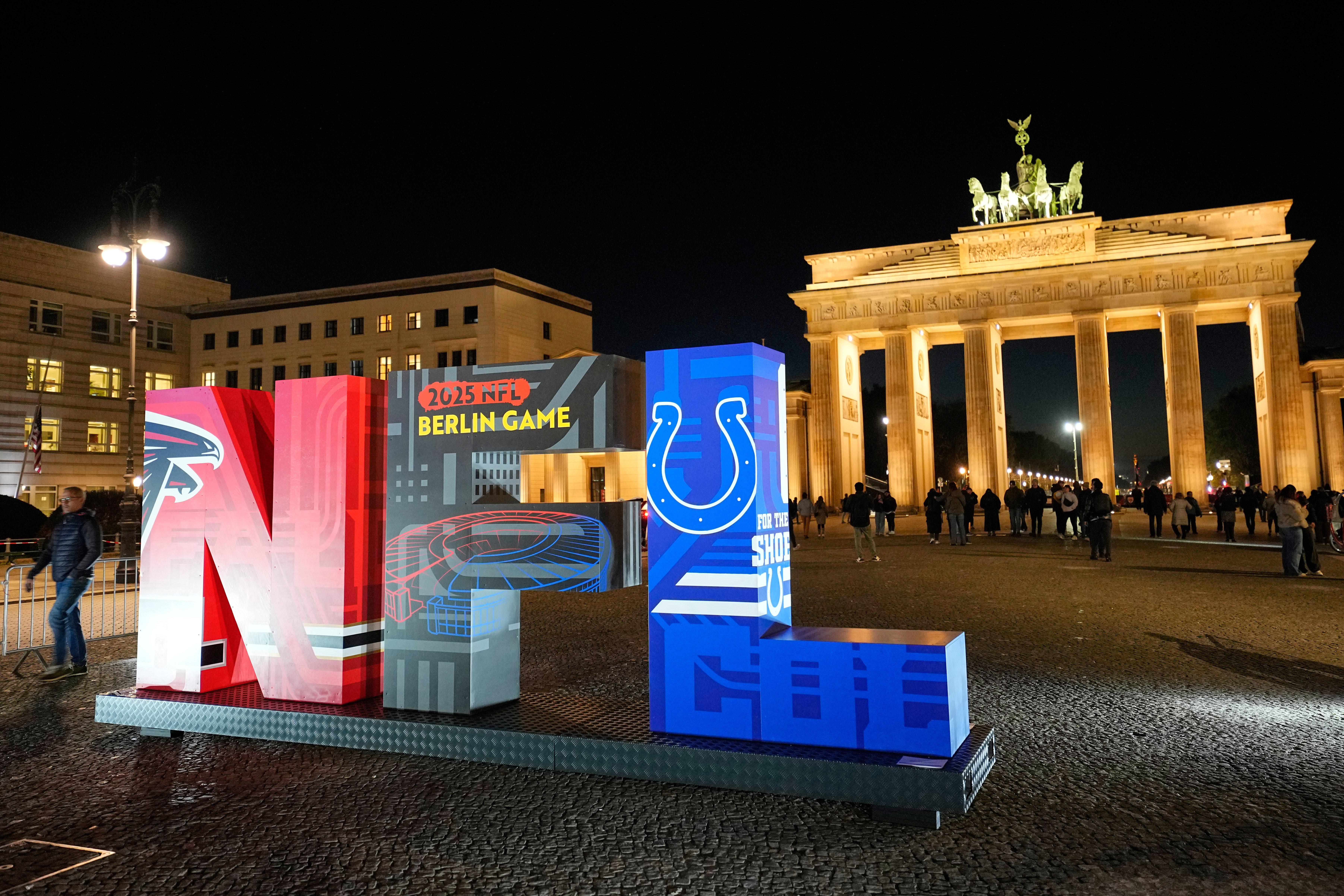 The NFL logo is illuminated in front of the Brandenburg Gate in Berlin, Germany, Thursday, Nov. 6, 2025, during an event promoting the NFL ahead of the upcoming game between the Indianapolis Colts and the Atlanta Falcons. (AP Photo/Martin Meissner)
